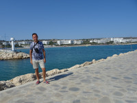 2021.07.27 On the embankment forming the bay of the Ayia Napa port, with the left lighthouse of the entrance to the bay, on the way to the lighthouse on the right.