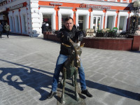 2022-03-16. Stradded the “Merry Goat” sculpture on the Theater Square of Nizhny Novgorod (Russia), the front view to the “Сhoсoladnitsa” cafe.