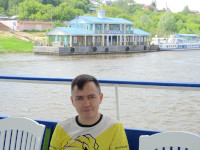2022-06-10. A view to Murom (and me) from a pleasure boat departing from the pier to the Oka river (the Vladimir region, Russia).