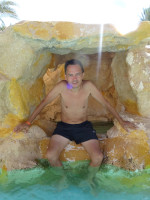 2022-08-20. An artificial cave in the cascade of swimming pools of the “Zahabia” hotel: I am sitting in it like in an armchair.