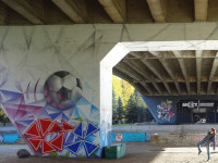 2022-10-09. I am depicting hitting a soccer ball about the size of me, beautifully painted on one of the pillars of one of the Kaliningrad bridges.