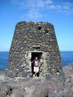 /201.60.52 As a guardian of a strange stone tower on a coast of the volcanic island of Tenerife.