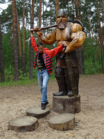 2022.06.19 Width a wooden sculpture of another fairy bogatyr in the “Fairy Tale” Park in Gus-Khrustalny (the Vladimir region, Russia).