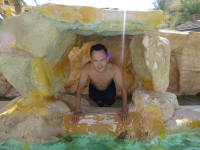 2022.08.20 An artificial cave in the cascade of swimming pools of the “Zakhabia” hotel: I have climbed inside it and am looking out of it.