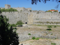 Вид на Старый город Родос (Παλιά πόλη Ρόδου) издалека, с улицы этнарха Макария (Εθνάρχης Μακάριος), так что видна высота крепостных стен и ров-пустырь перед ними.